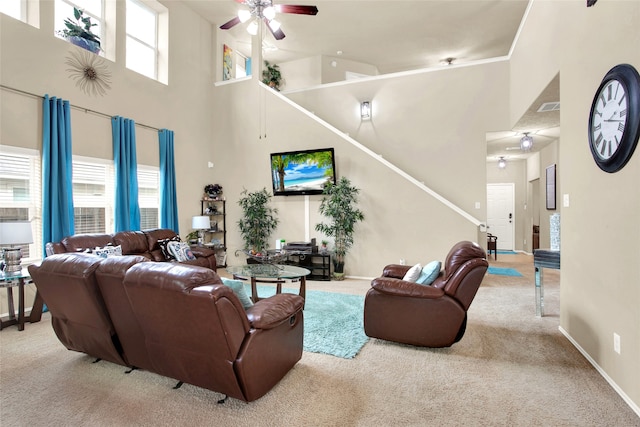 living room featuring ceiling fan, crown molding, light carpet, and high vaulted ceiling