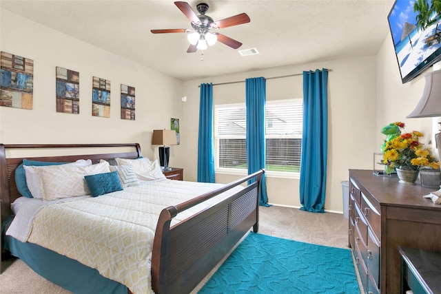 bedroom with ceiling fan and light carpet