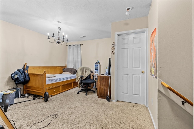 bedroom featuring carpet floors, a textured ceiling, and a notable chandelier