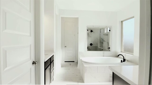 bathroom with tiled bath and vanity