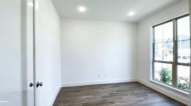 spare room featuring dark hardwood / wood-style flooring