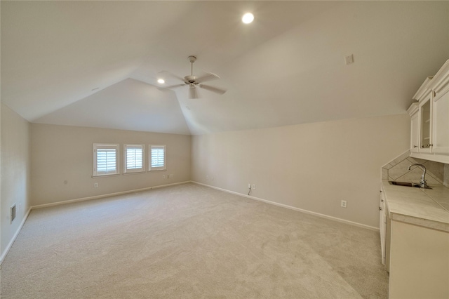 bonus room featuring light carpet, ceiling fan, lofted ceiling, and sink