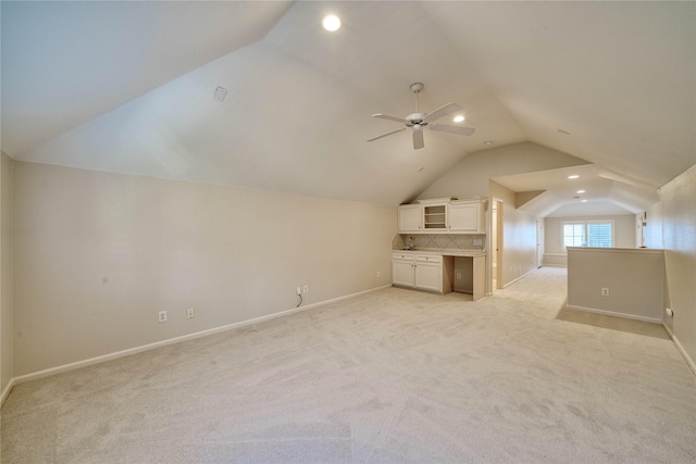 additional living space with light colored carpet, ceiling fan, and lofted ceiling