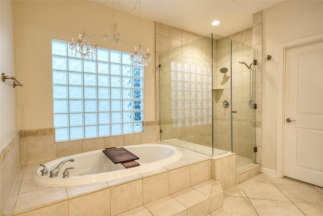 bathroom with tile patterned floors, a notable chandelier, separate shower and tub, and plenty of natural light