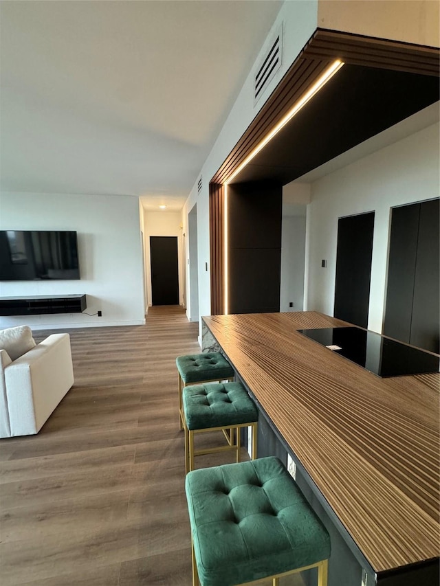 interior space with cooktop and hardwood / wood-style floors