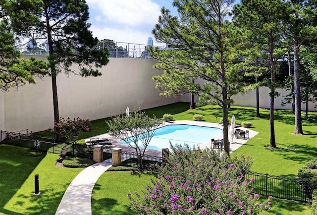 view of swimming pool featuring a patio area and a lawn