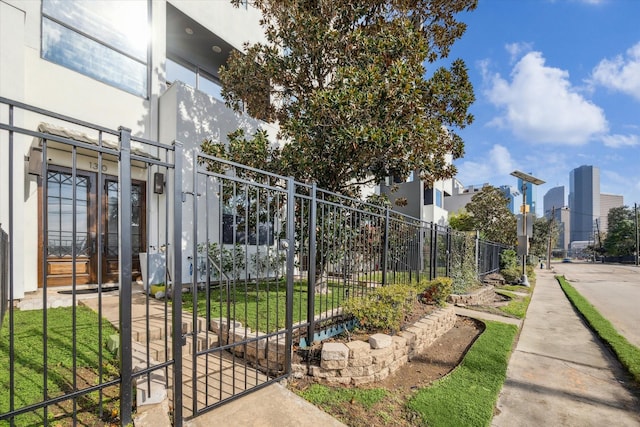 view of gate with a lawn