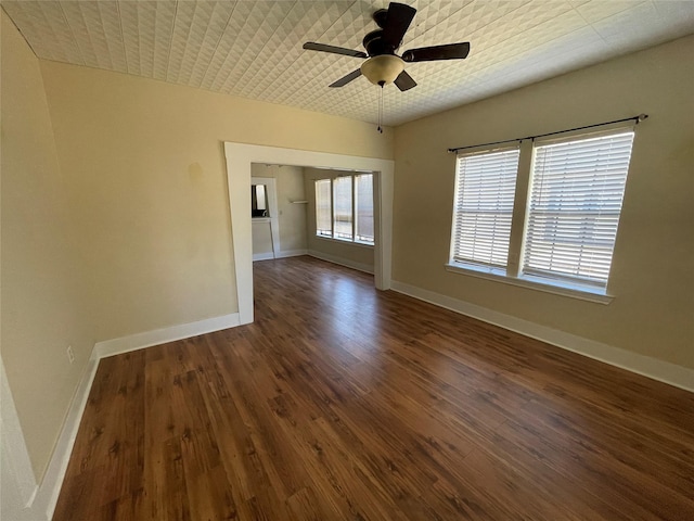 unfurnished room with dark hardwood / wood-style floors and ceiling fan