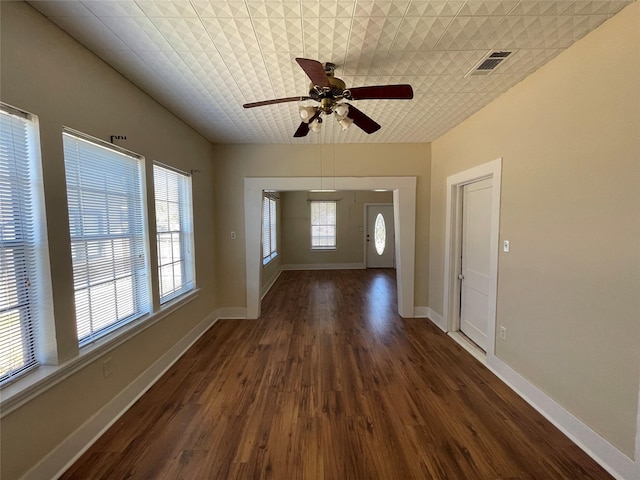 entryway with plenty of natural light, dark wood-type flooring, and ceiling fan