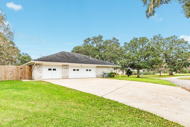 view of front of property featuring a garage and a front lawn