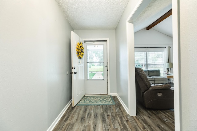 doorway featuring a textured ceiling, vaulted ceiling with beams, dark hardwood / wood-style flooring, and plenty of natural light