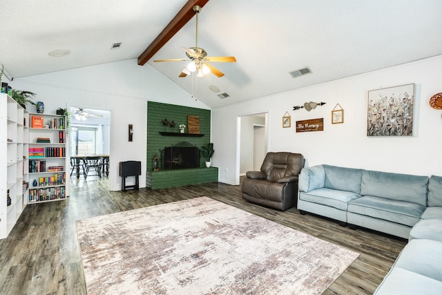 living room with lofted ceiling with beams, dark hardwood / wood-style floors, and a brick fireplace