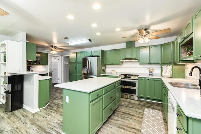 kitchen with a center island, stainless steel appliances, and green cabinetry