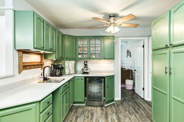 kitchen featuring green cabinets, sink, decorative backsplash, dark hardwood / wood-style floors, and beverage cooler