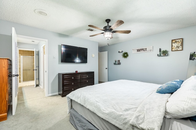 carpeted bedroom with ceiling fan and a textured ceiling