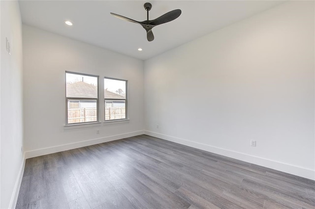 empty room with hardwood / wood-style flooring and ceiling fan