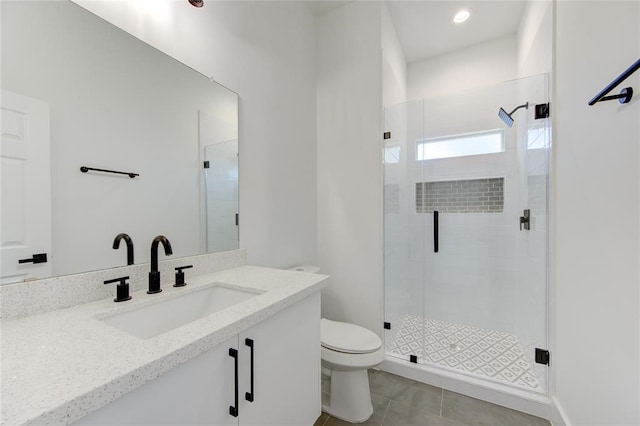 bathroom with vanity, tile patterned flooring, a shower with shower door, and toilet