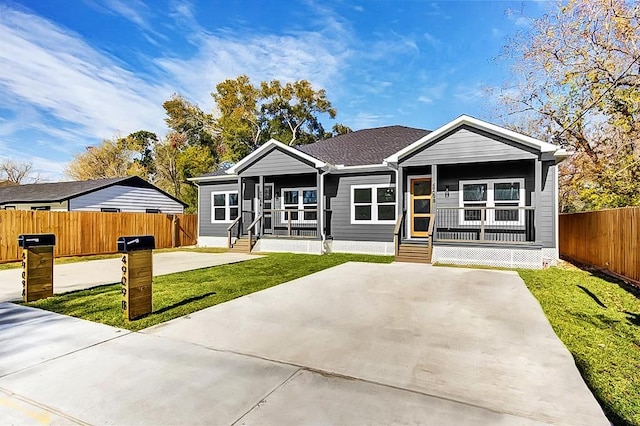 view of front of home with a porch and a front yard