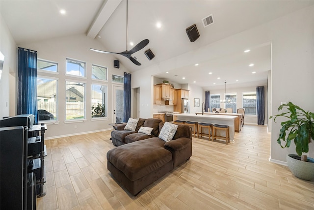 living room with ceiling fan, a healthy amount of sunlight, light wood-type flooring, and sink