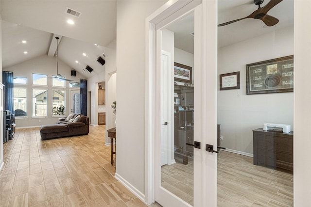 hallway with beam ceiling, high vaulted ceiling, and french doors