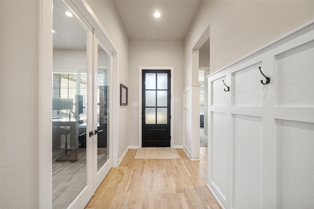 doorway to outside featuring light hardwood / wood-style floors and french doors