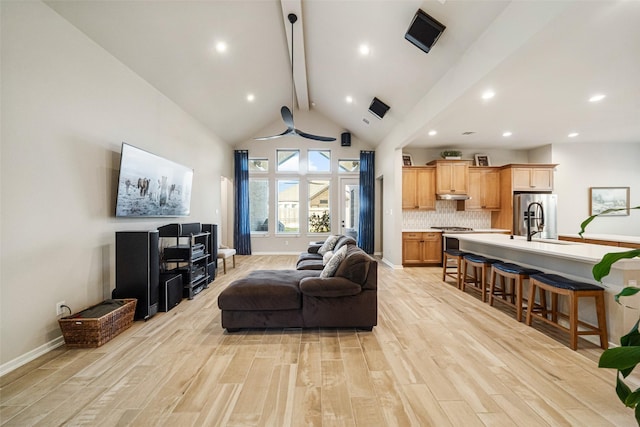 living room featuring beamed ceiling, ceiling fan, light wood-type flooring, and high vaulted ceiling