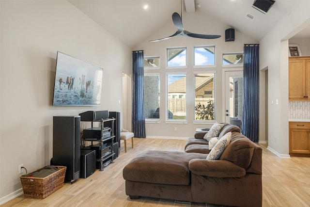 living room with light wood-type flooring, high vaulted ceiling, and ceiling fan