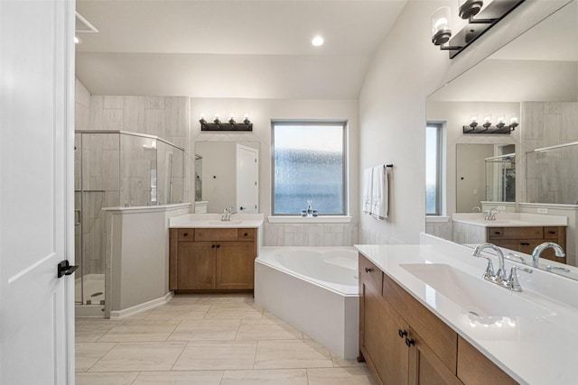 bathroom featuring vanity, lofted ceiling, and independent shower and bath