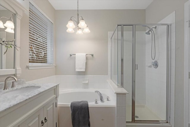 bathroom with vanity, an inviting chandelier, and separate shower and tub