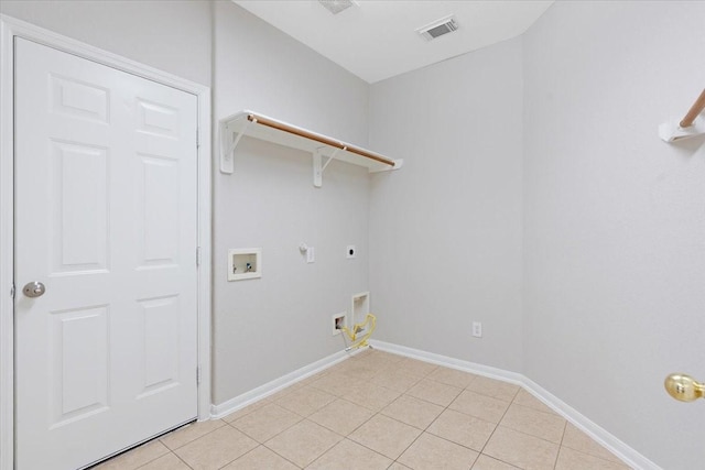 washroom with hookup for an electric dryer, hookup for a gas dryer, light tile patterned floors, and washer hookup