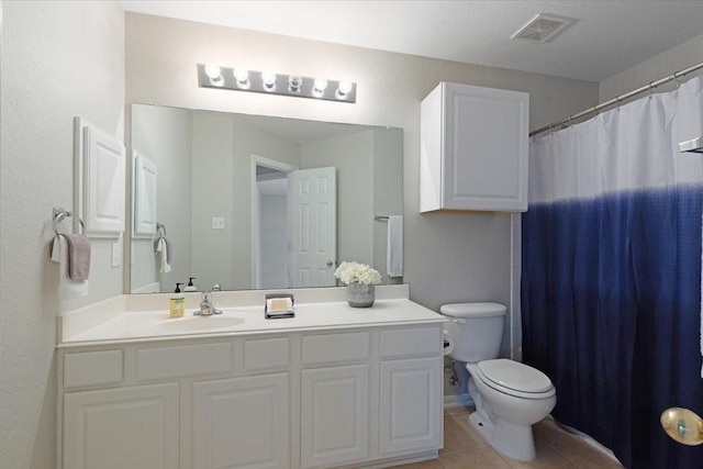 bathroom featuring tile patterned floors, vanity, and toilet