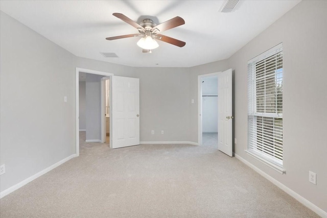 unfurnished bedroom featuring ceiling fan and light carpet