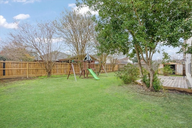 view of yard featuring a playground and a wooden deck