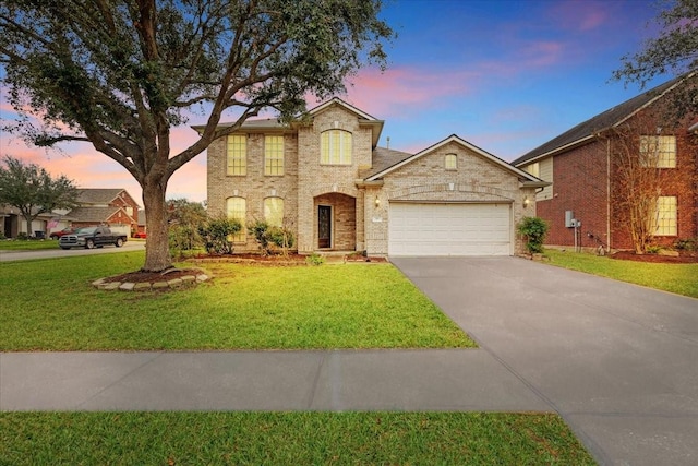 view of front facade with a yard and a garage