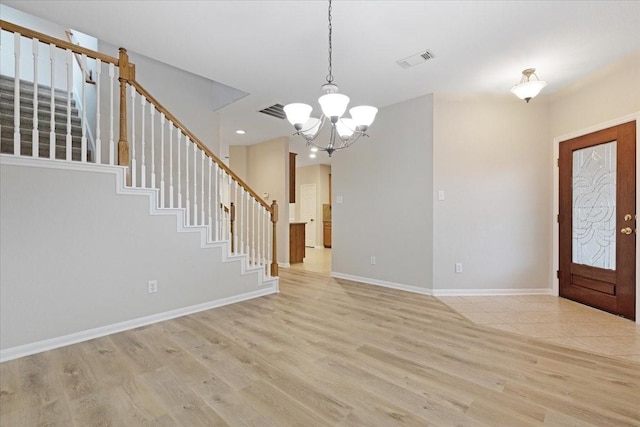 foyer entrance featuring a chandelier and light hardwood / wood-style flooring