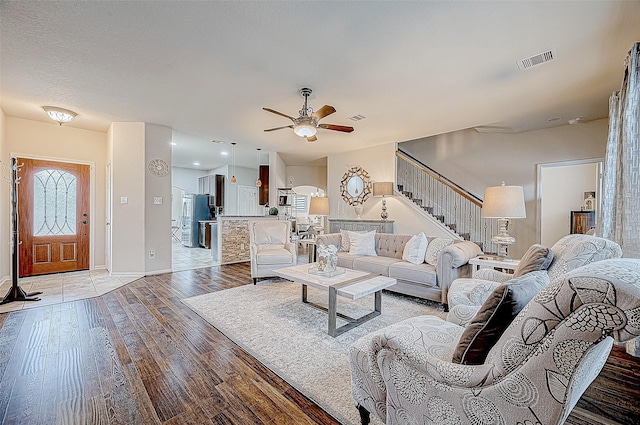 living room with ceiling fan and wood-type flooring