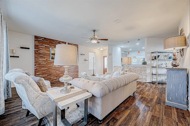 living room with dark hardwood / wood-style floors and ceiling fan