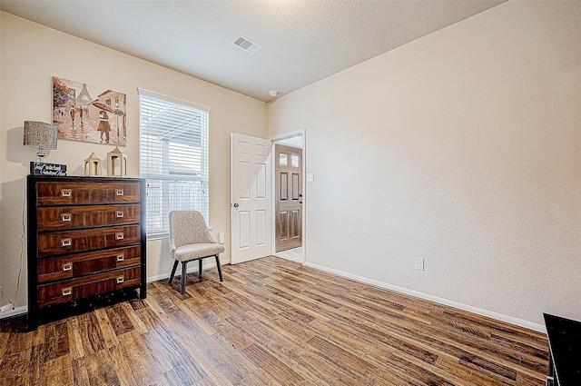 sitting room featuring wood-type flooring and a wealth of natural light