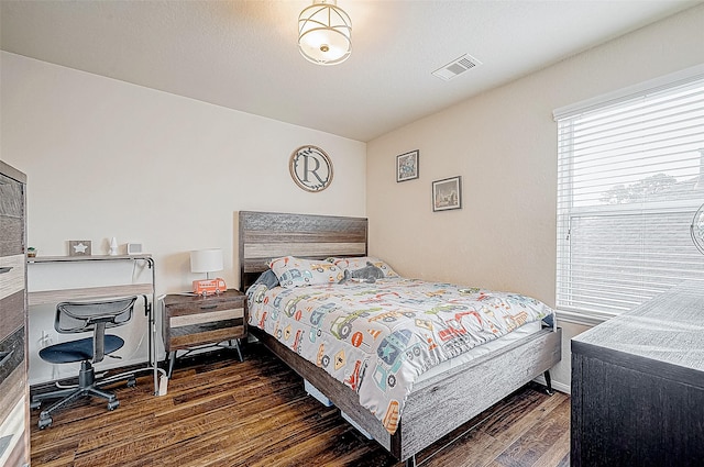 bedroom featuring dark hardwood / wood-style flooring