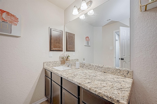 bathroom with vanity and a wall mounted AC