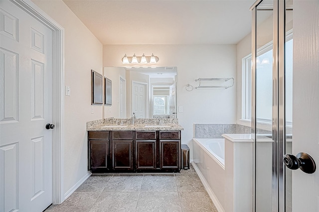 bathroom with vanity and independent shower and bath