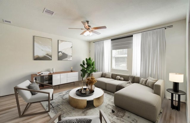 living room with ceiling fan and hardwood / wood-style flooring