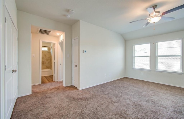 carpeted spare room featuring ceiling fan