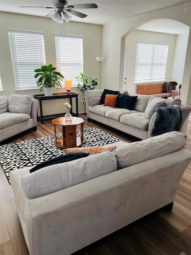 living room featuring wood-type flooring and ceiling fan