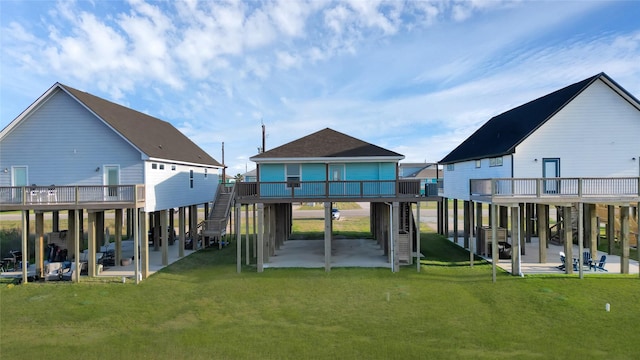 back of house with a yard, a patio, and a wooden deck