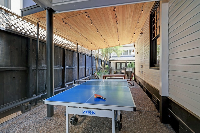 playroom featuring wood walls, wooden ceiling, and vaulted ceiling