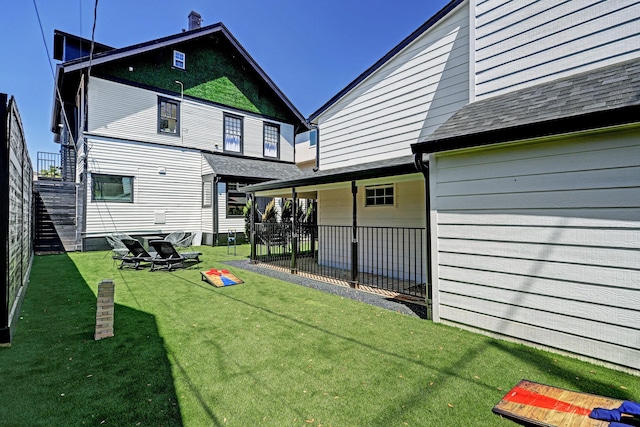 rear view of house featuring a lawn