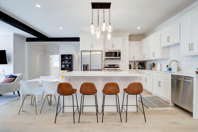 kitchen with white cabinetry, a kitchen island, and stainless steel appliances