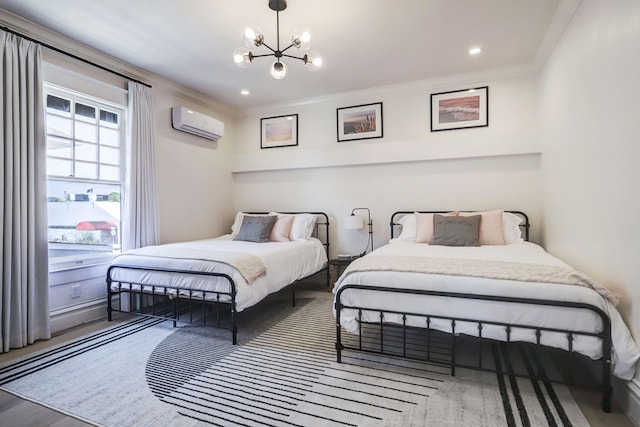 bedroom featuring hardwood / wood-style floors, an inviting chandelier, an AC wall unit, and ornamental molding