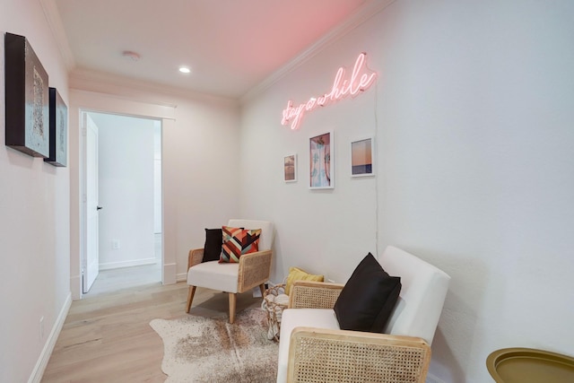 living area featuring light hardwood / wood-style floors and ornamental molding